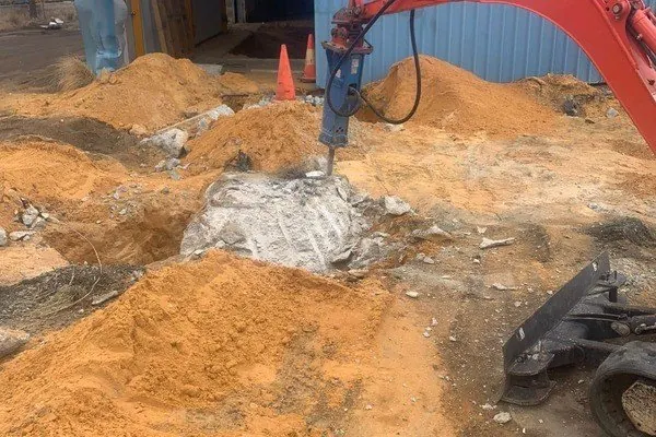 Breaking out buried concrete in a sandy backyard